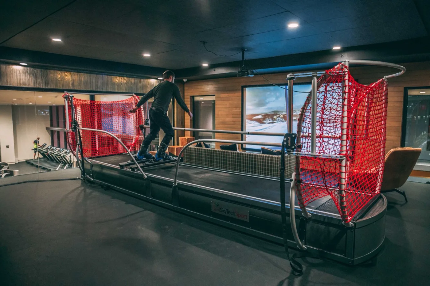 A member skiing on a SkyTechSport simulator in an upscale club