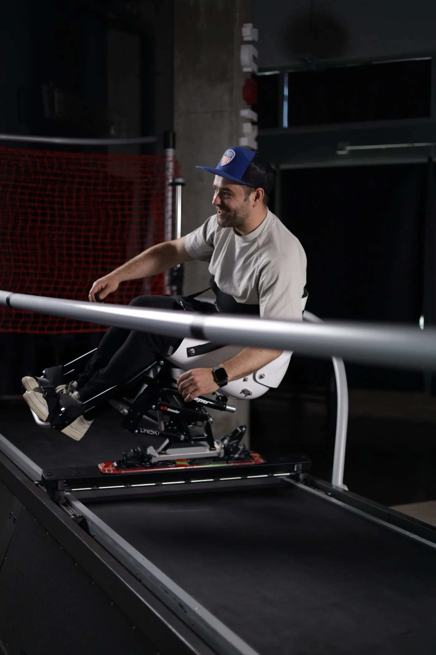 An adaptive sit-ski athlete training on a SkyTechSport ski simulator