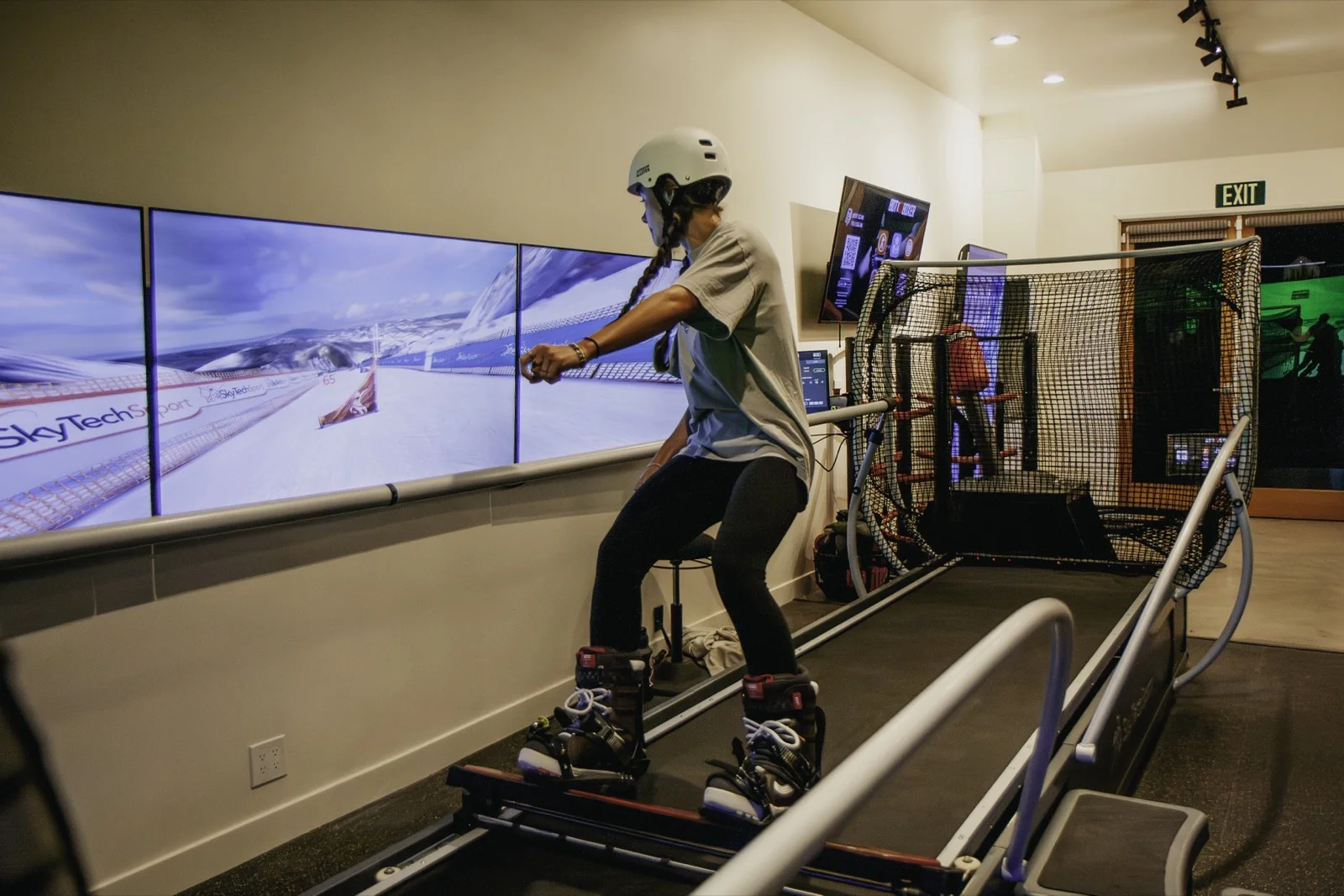 An athlete skiing a SkyTechSport simulator at a commercial venue